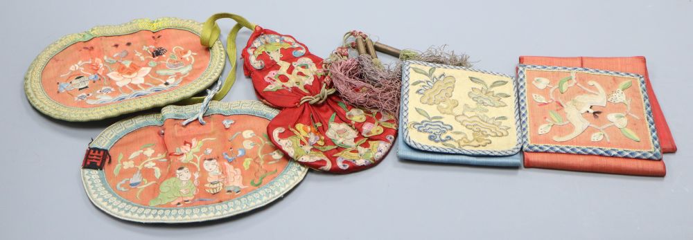 A collection of five Chinese embroidered purses, a red silk applique worked purse with silk tassels, finely embroidered petit point pur